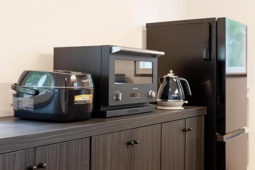 a kitchen counter with a toaster and a blender on it at Villa Noël Hakone Fuji Sauna&Open Air Bath in Hakone