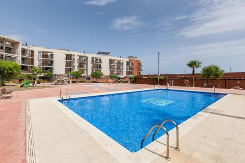a large swimming pool in front of a building at Cubelles mar in Cubelles
