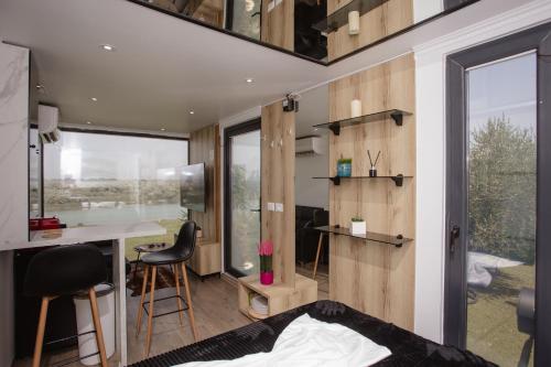 a bedroom with a bed and a desk in a room at 446 Tiny House Shirokë in Široka