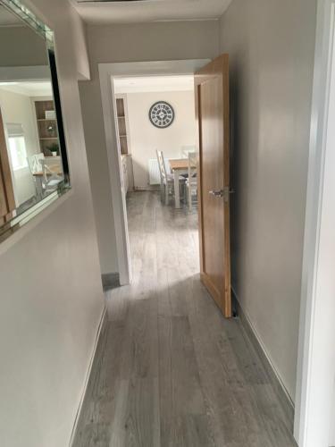 a hallway with a door leading to a dining room at Farsnagh Cottage in Newport Trench