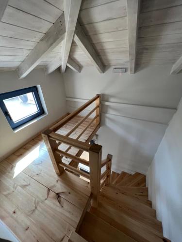 an attic room with a staircase and a window at Maria’s family house’s in Elafonisos