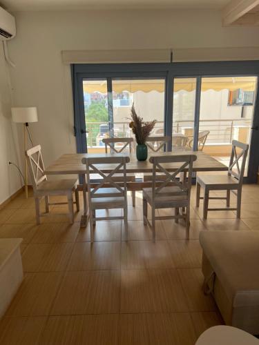 a dining room with a table and chairs and a table at Maria’s family house’s in Elafonisos