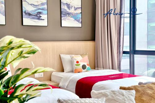 a bedroom with two beds and a potted plant at Alviv 99 Suites I Family Suite I 4-7 pax I 5minsMelakaCruise I JonkerSt in Melaka