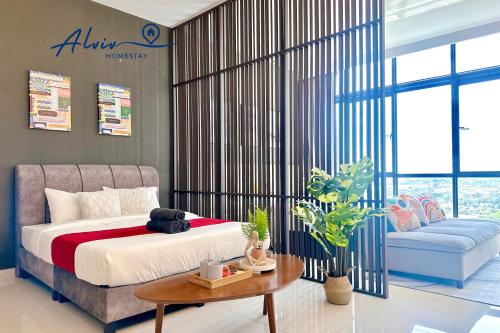 a bedroom with a bed and a table and a couch at Alviv 99 Suites I Family Suite I 4-7 pax I 5minsMelakaCruise I JonkerSt in Melaka