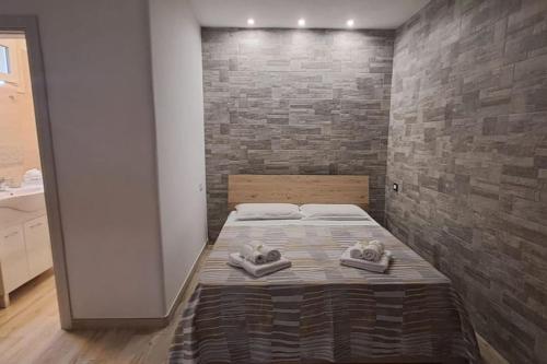 a bedroom with a bed with towels on it at Punta Grossa - Porto Cesareo in Punta Prosciutto