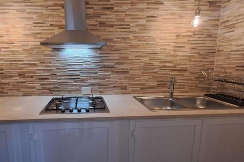 a kitchen with a sink and a stove at Punta Grossa - Porto Cesareo in Punta Prosciutto