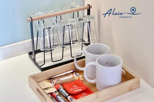 a wooden tray with cups and utensils on a counter at Alviv 99 Suites I Family Suite I 4-7 pax I 5minsMelakaCruise I JonkerSt in Melaka