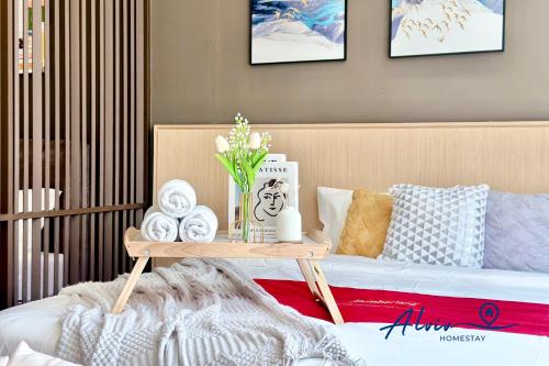 a room with a bed and a table with towels at Alviv 99 Suites I Family Suite I 4-7 pax I 5minsMelakaCruise I JonkerSt in Melaka