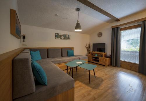 a living room with a couch and a tv at Ferienwohnung Kobler in Landeck