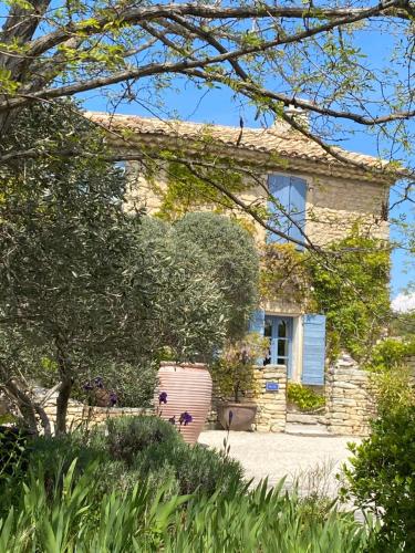 a stone house with a garden in front of it at Mas de la Beaume in Gordes