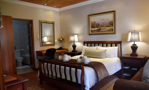 a bedroom with a bed with two teddy bears on it at LUXURY ROOM @ 4 STAR GUEST HOUSE in Middelburg