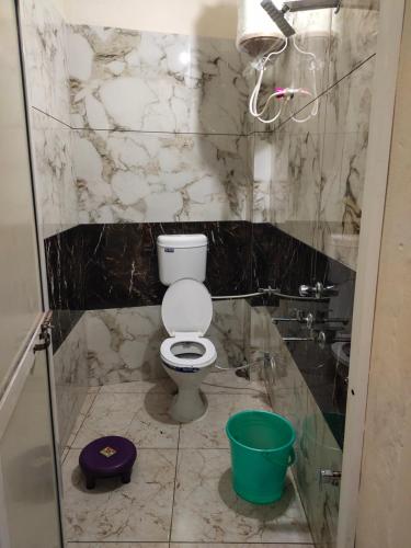 a bathroom with a toilet and a sink at Rajdarshan Hotel in Ujjain
