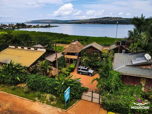 an aerial view of a village with a car parked in a driveway at Home On The Nile water front Cottage in Jinja