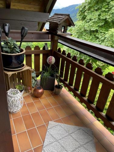 a balcony with potted plants and a bird house at Ferienwohnung Martens Villa in Bad Aussee