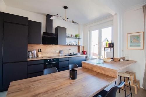 a kitchen with a wooden counter top and a table at Plein centre de Waterloo! in Waterloo