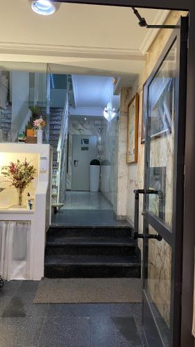 a hallway with stairs in a building with a door at Rincón Extremeño in Plasencia