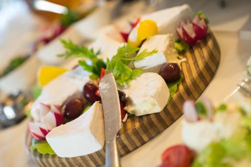 two plates of food with cheese and fruit on a table at Oasis Resort & Spa in Rewal