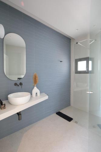 a bathroom with a sink and a mirror at Anapollo Boutique Hotel Adults Only in Naxos Chora