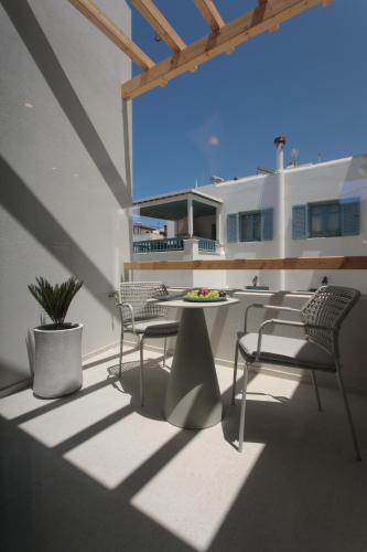 a balcony with chairs and a table on a building at Anapollo Boutique Hotel Adults Only in Naxos Chora