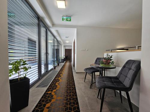 a hallway with chairs and a table in a building at BudinSKI Apartmány & Wellness in Liptovský Mikuláš