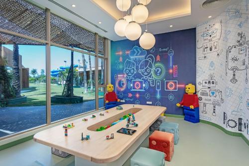 a room with a table and four lego figures on the wall at Titanic Deluxe Lara in Lara