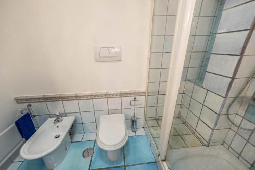a bathroom with a toilet and a sink at Villa Patrizia in Minturno