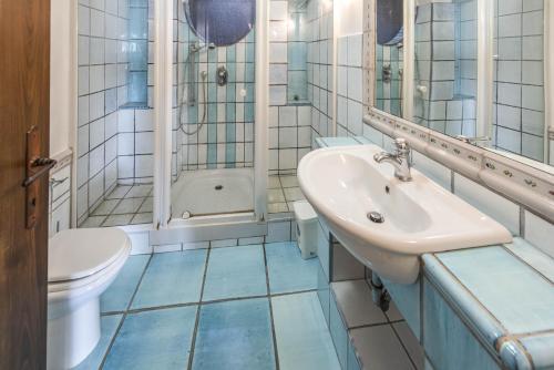 a bathroom with a sink and a shower and a toilet at Villa Patrizia in Minturno