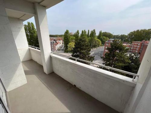 an empty balcony with a view of a city at Superbe appartement proche de la plage in Dunkerque