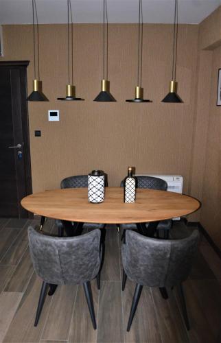 a dining room table with chairs and pendant lights at Casa Nuova in Kotor