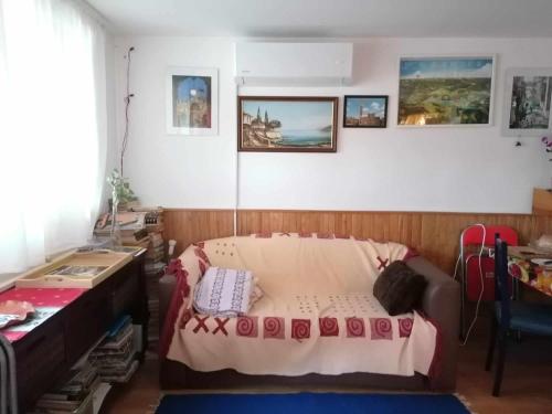 a bedroom with a bed and a table and a desk at SUNSHINE house in Orfű
