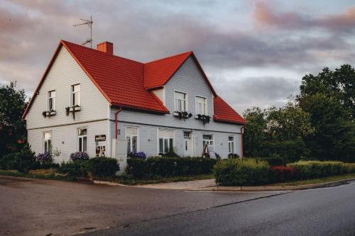 a large white house with a red roof at Skrunda Apartments Centrum in Skrunda