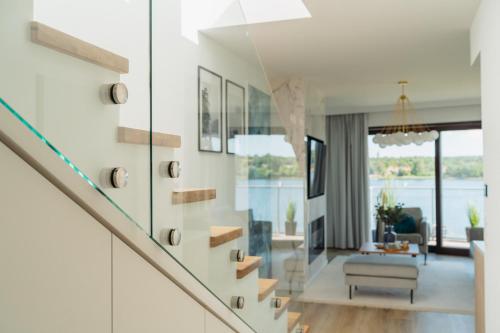 a staircase in a house with a living room at Sol Marina Resort Wyspa Sobieszewska I - LoftAffair Collection in Wiślinka