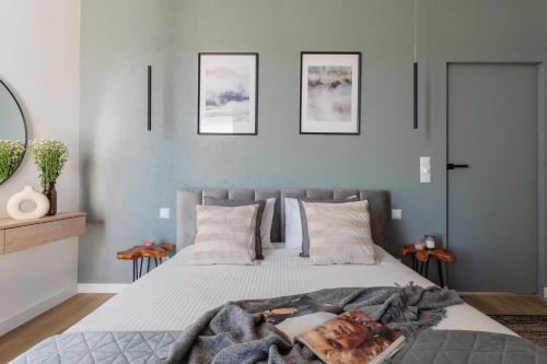 a bedroom with a bed with a blanket on it at Sol Marina Resort Wyspa Sobieszewska I - LoftAffair Collection in Wiślinka