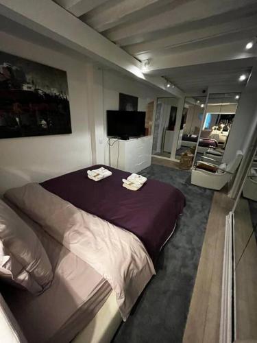 une chambre avec un grand lit avec deux serviettes dessus dans l'établissement Appartement avec cachet Arc-de-Triomphe, à Paris