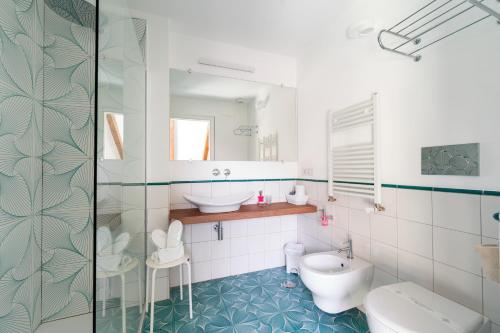 a bathroom with a toilet and a sink and a mirror at Hotel Villa Annalara charme and Relax in Amalfi