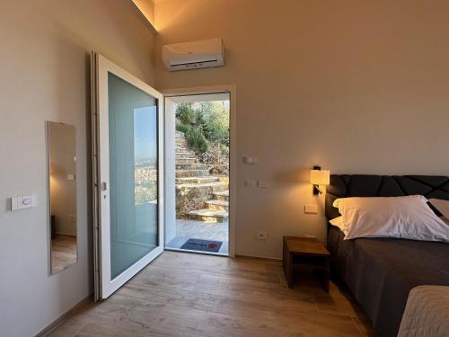a bedroom with a bed and a sliding glass door at 88 Miglia in La Spezia