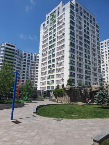 a large apartment building with a park in front of it at Акварелі 2 in Vyshneve