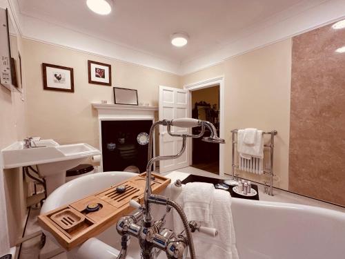 a bathroom with a bath tub and a sink at Porters Coffee Shop and B&B in Helmsley