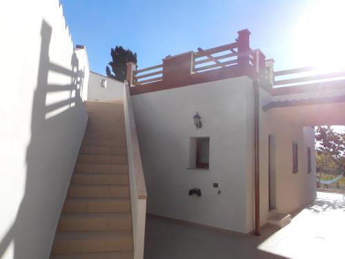 a stairway leading up to a white building with stairs at SERRA E MESU Affittacamere in Magomadas