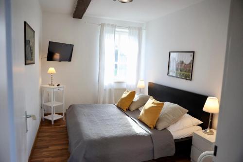 a bedroom with a bed with yellow pillows on it at Gut Basthorst in Basthorst