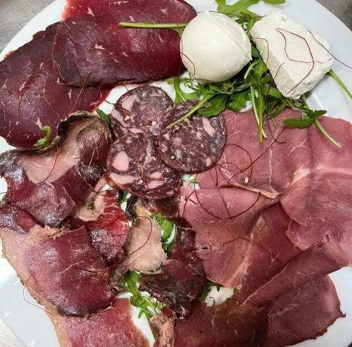 a plate of food with meat and vegetables on it at B&B Tenuta San Michele in Capaccio-Paestum