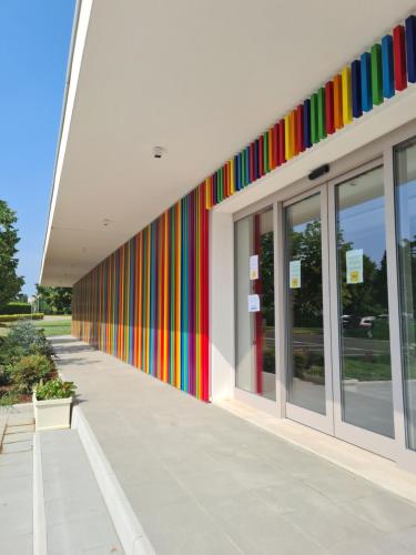a building with colorful stripes on the side of it at Active Hotel Paradiso in Peschiera del Garda