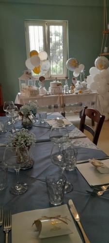 a table with a blue table cloth and glasses on it at B&B Tenuta San Michele in Capaccio-Paestum