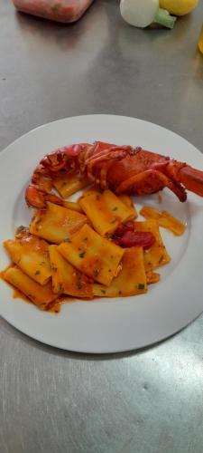 a plate of food with a crab and potatoes at B&B Tenuta San Michele in Capaccio-Paestum