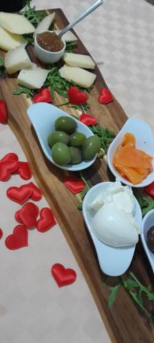 a wooden cutting board with hearts and vegetables on it at B&B Tenuta San Michele in Capaccio-Paestum