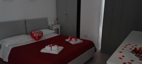 a bedroom with a bed with two towels and a red pillow at B&B Tenuta San Michele in Capaccio-Paestum
