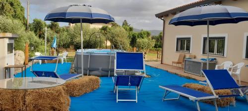 a group of chairs and tables with umbrellas at B&B Tenuta San Michele in Capaccio-Paestum