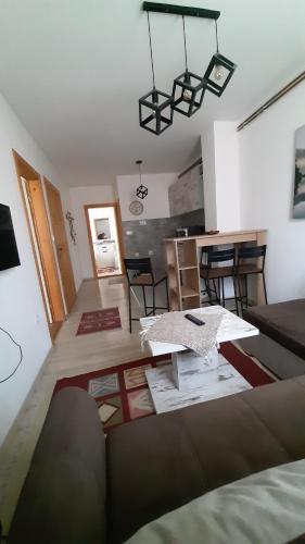 a living room with a couch and a kitchen at Apartments Durmitor in Žabljak