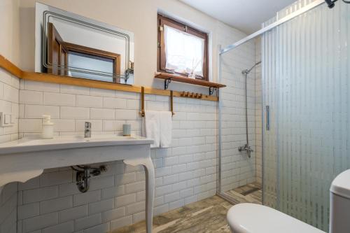 a bathroom with a sink and a shower at Aral Tatil Ciftligi in Bozcaada