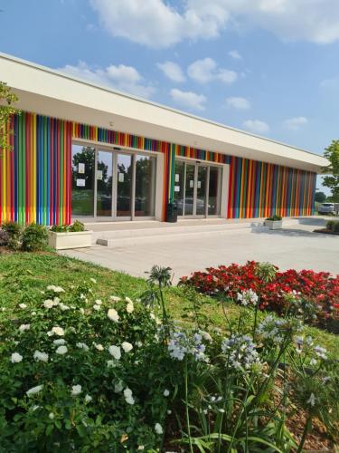 a building with a colorful facade with flowers at Parc Hotel in Peschiera del Garda